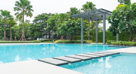 Beautiful luxury swimming pool with palm tree - Boost up color Processing