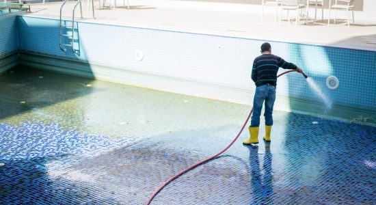 A man cleaning pool