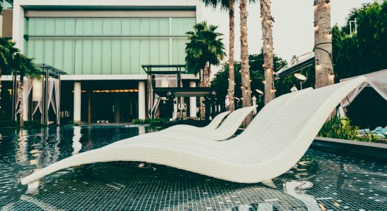 Beautiful luxury pool Chair in hotel swimming pool at Twilight times - Vintage filter Processing