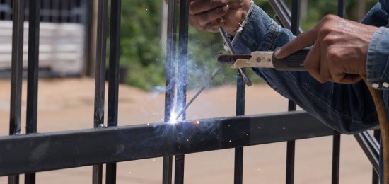 worker welding at manufacturing , welding door frames
